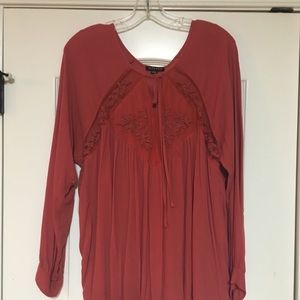 Red long sleeve top with lace cutouts